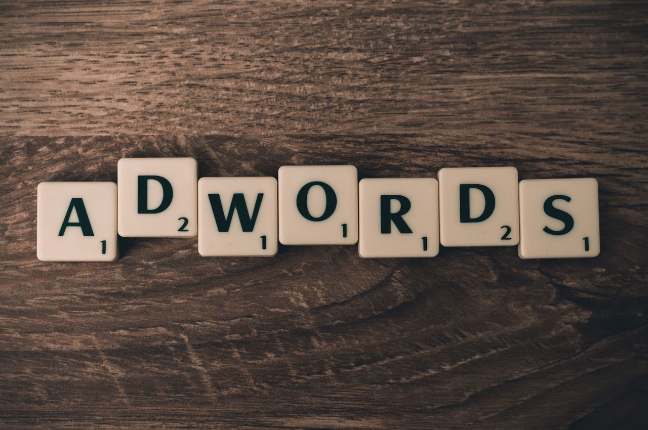 services-03 Scrabble tiles spelling AdWords on a wooden surface, symbolizing digital marketing concepts.